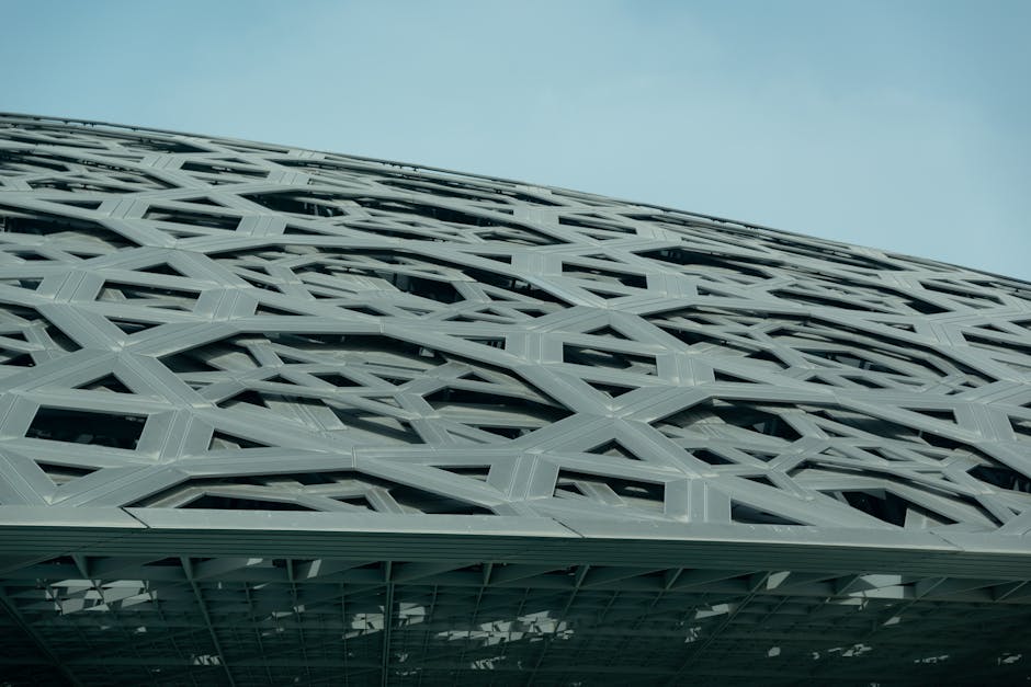 Close-up view of the modern architectural design of Louvre Abu Dhabi's roof structure.