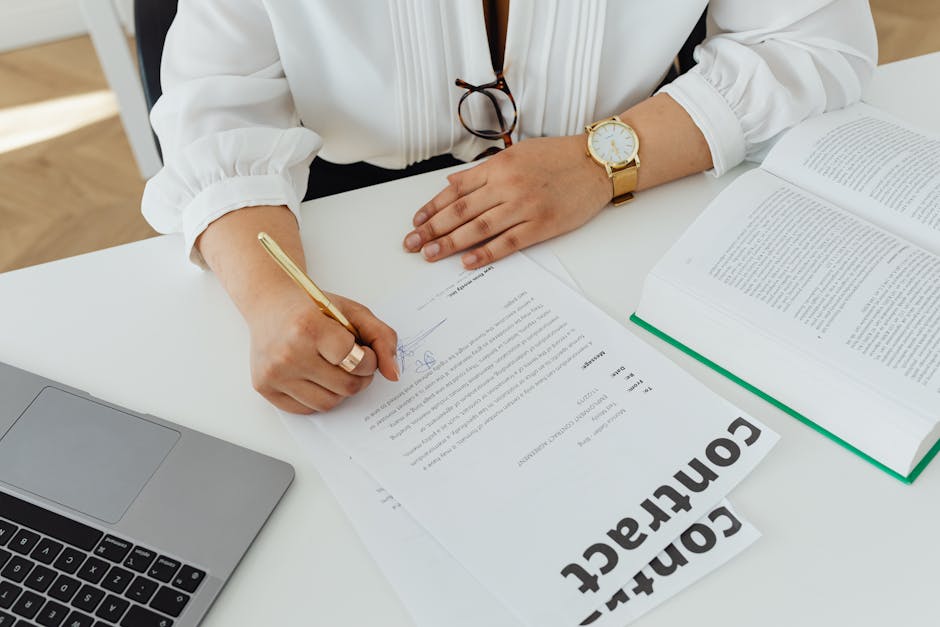 freelancer signing contract Arabic office pen laptop