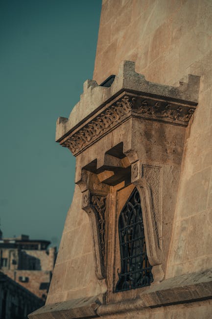 Stone facade with intricate carvings highlights Aleppo's architectural heritage under warm daylight.