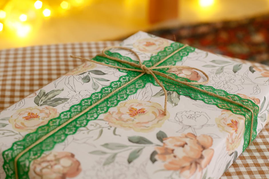 Beautifully wrapped floral gift box tied with green ribbon, perfect for celebrations.
