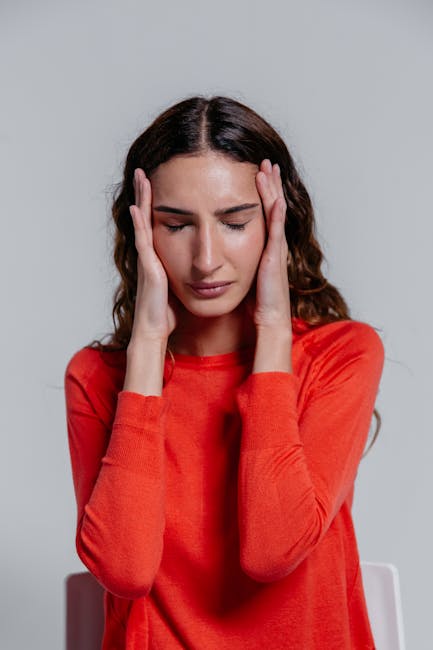 woman holding head tired period calendar