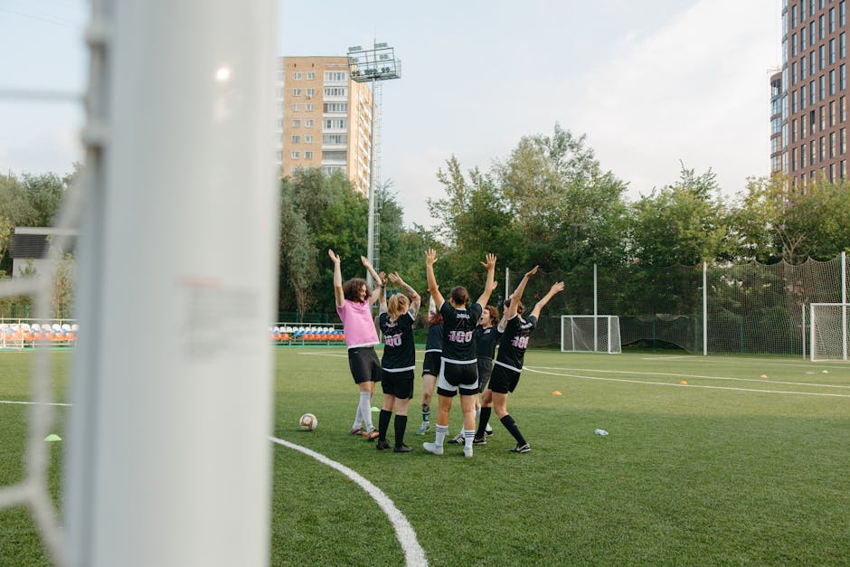 women soccer team celebrating match cheering stadium evening