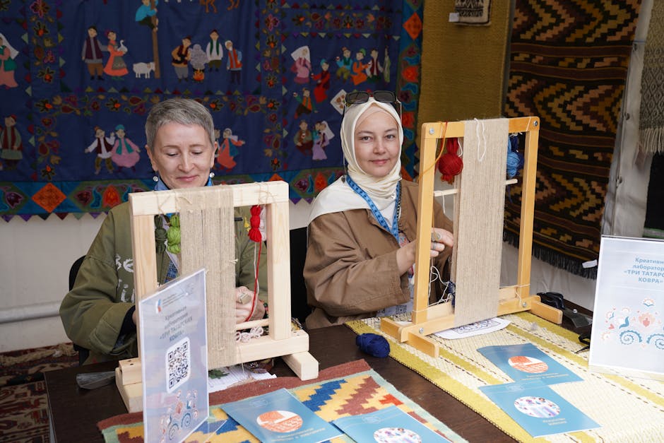 Two women engaging in traditional textile weaving at an arts and crafts workshop, demonstrating cultural heritage.