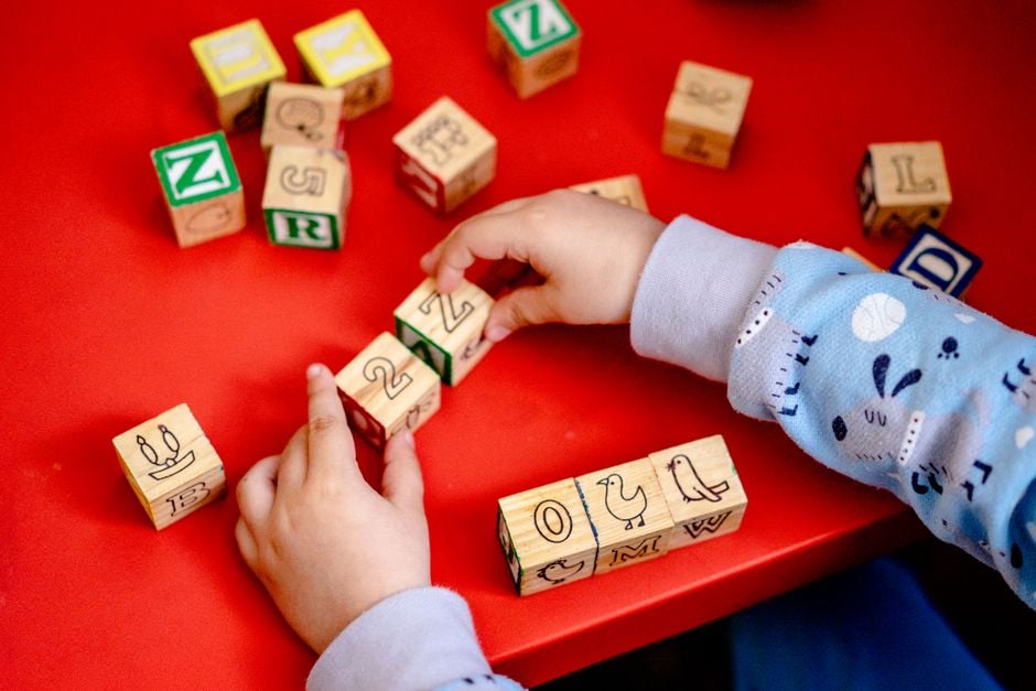 child playing wooden blocks colorful preschool pexels