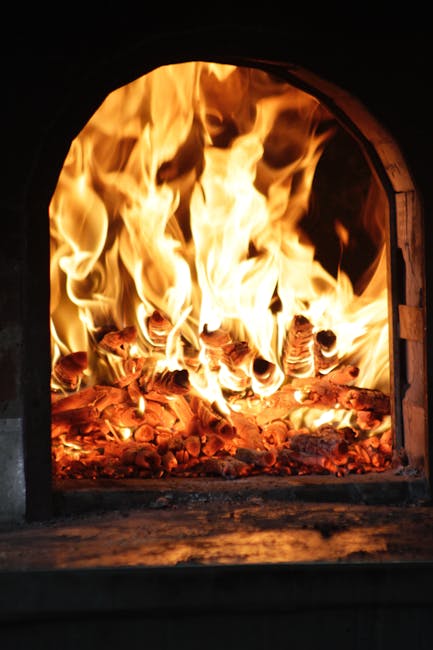 Close-up of intense flames in a traditional fireplace, evoking warmth and energy.