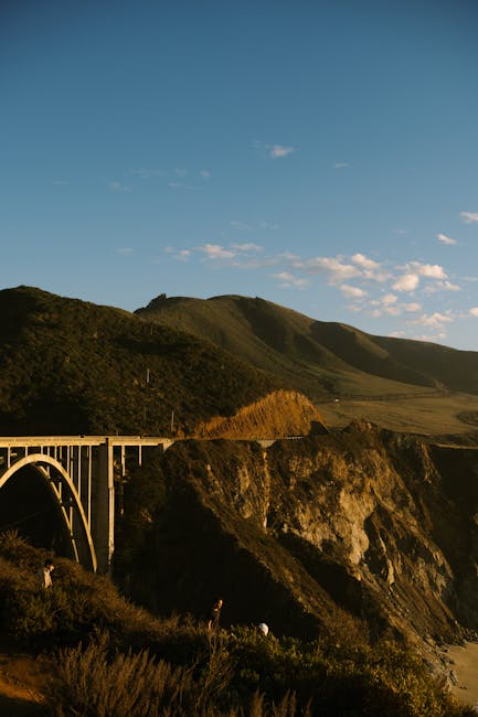 Dramatic landscape of Bixby Creek Bridge with stunning coastal scenery in golden light.