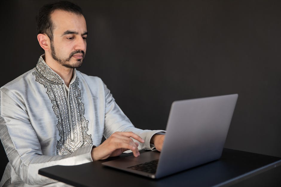 Arab professional on laptop LinkedIn profile office modern workplace