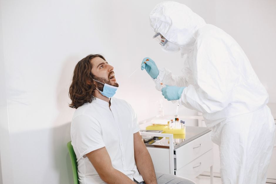 farm worker in PPE collecting poultry swab sampling virus
