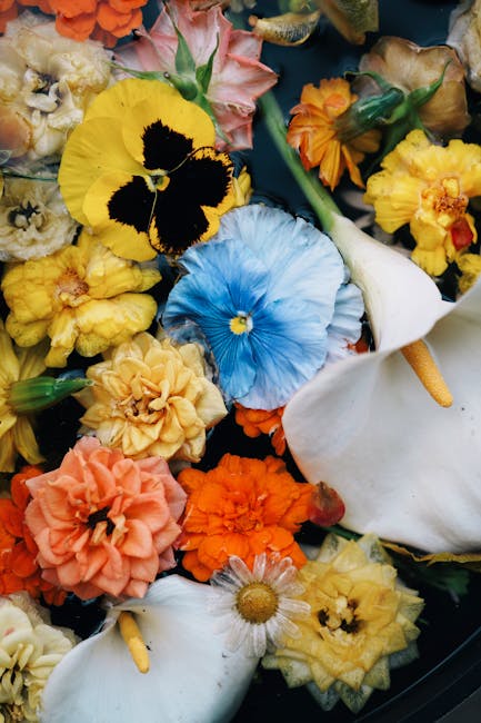 Colorful pansies, lilies, and marigolds beautifully arranged for a vibrant floral display.