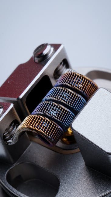 Closeup of fused clapton coil on dripper of modern electronic cigarette on white background