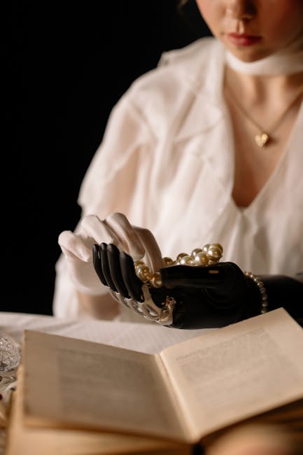An elegant woman with a prosthetic arm holding pearls, captured in soft lighting, creating a sophisticated, futuristic mood.