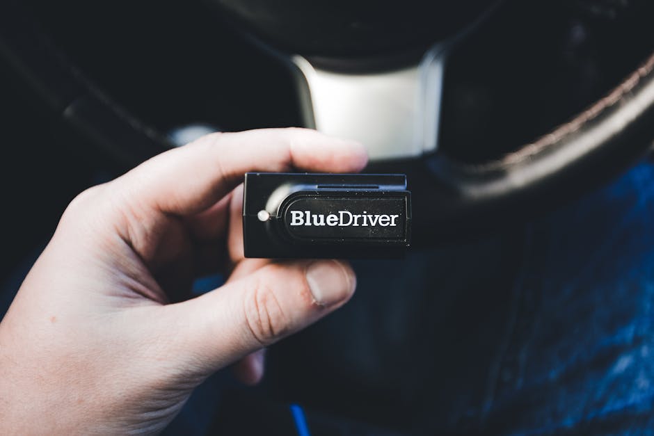 OBD2 scanner plugged into car dashboard mechanic