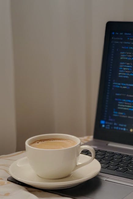 developer coding chatbot on laptop coffee shop