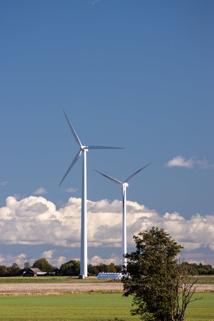 Wind turbines in the Swedish countryside under a clear blue sky. Renewable energy scene.