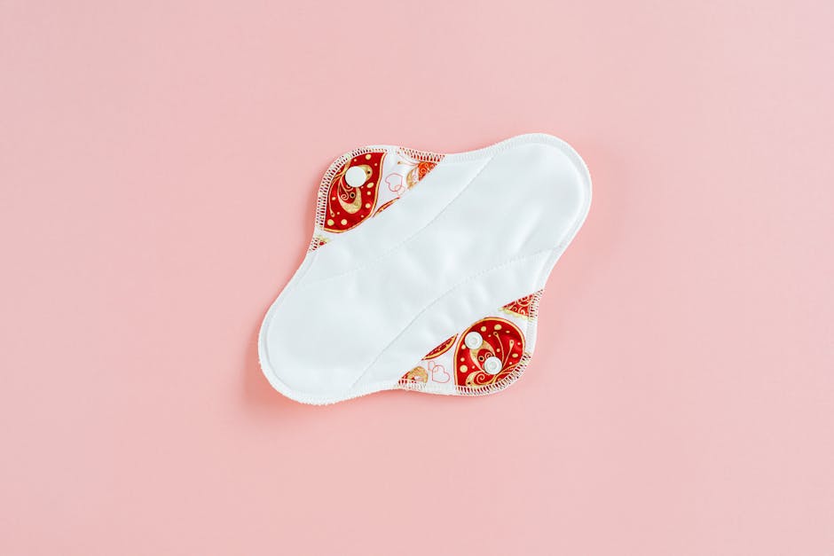 reusable cloth pads and menstrual cup flatlay neutral background