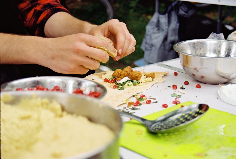 falafel pop-up vendor urban night market hands serving pita