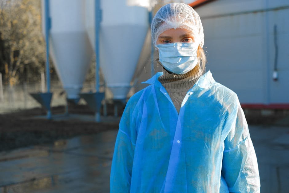 poultry farm worker in protective gear