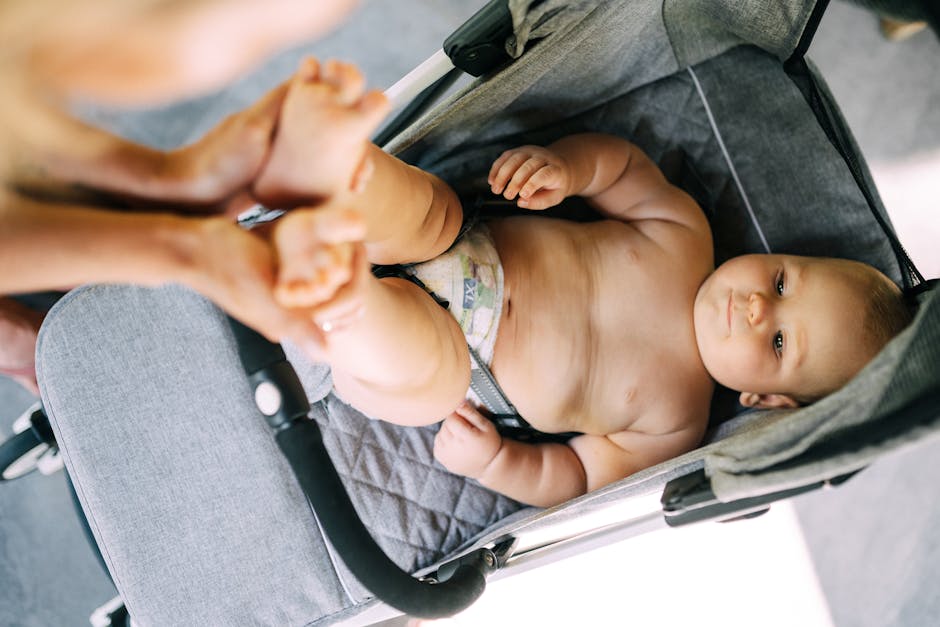 parent checking stroller harness close-up baby stroller safety check