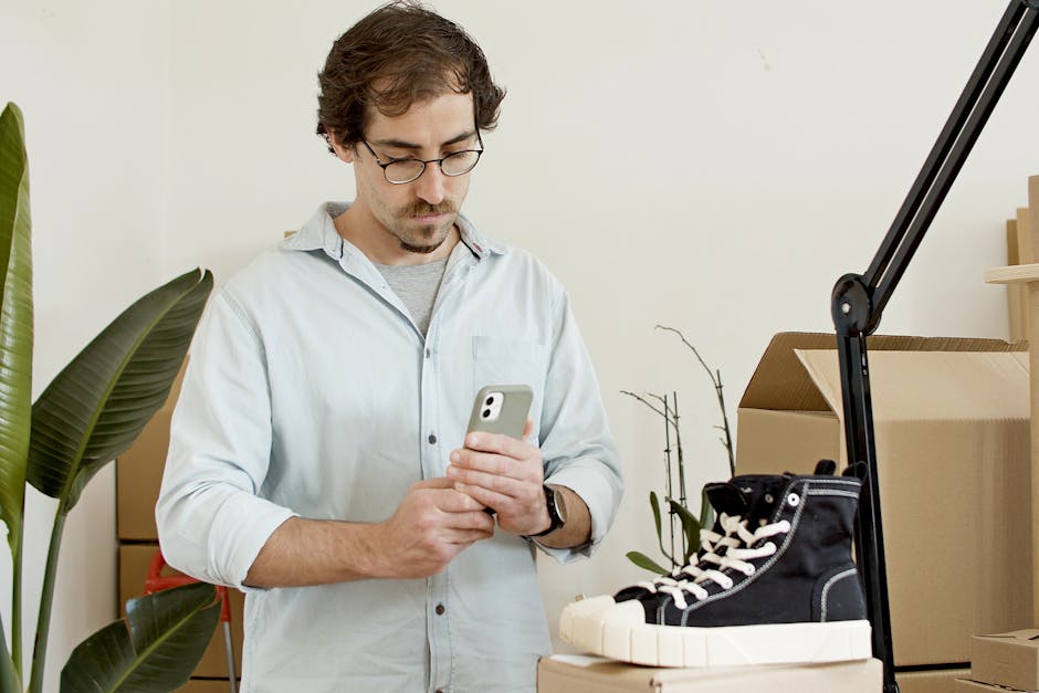 seller photographing product for online listing smartphone studio lighting
