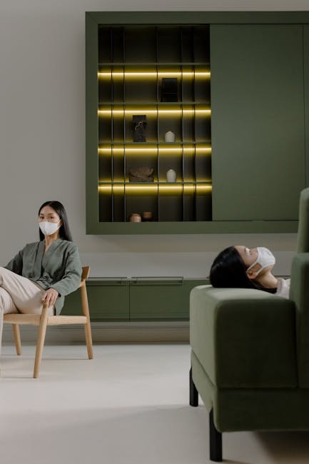 Indoor scene of two masked individuals exemplifying pandemic safety in a modern living room.