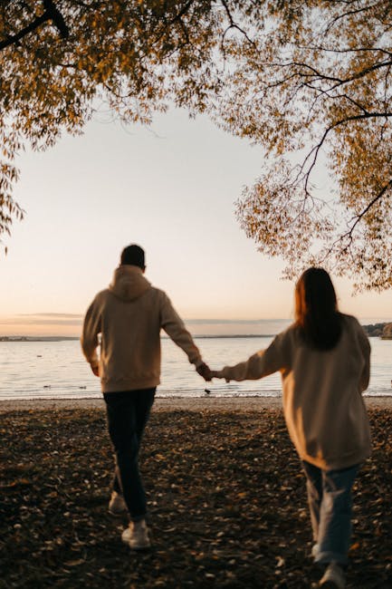 couple walking on Cape Cod beach at sunset romantic