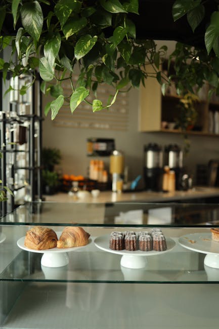 Inviting café counter showcasing croissants and muffins, set in a warm, cozy ambiance.