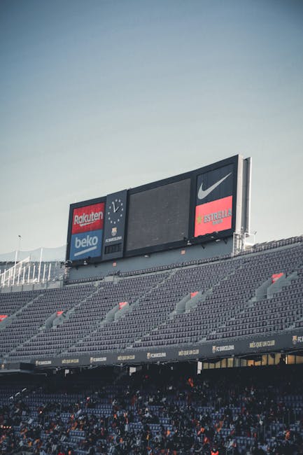 stadium sponsorship boards corporate logos crowd 2025