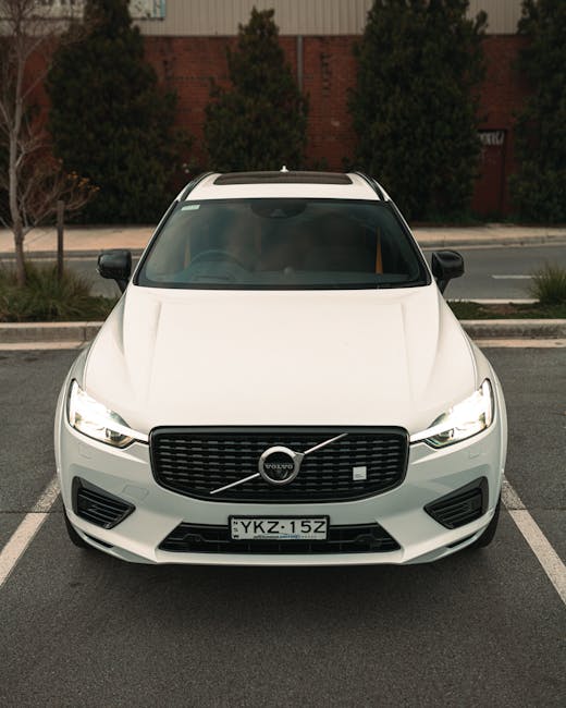 White Volvo SUV parked in an outdoor setting, showcasing a sleek, modern design. Ideal for automotive enthusiasts.