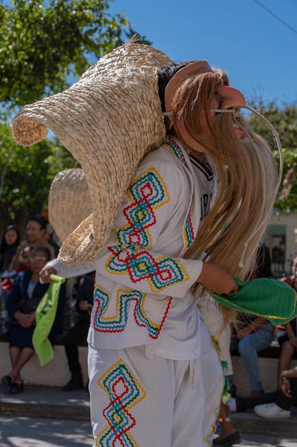 Man in vibrant South American costume performing at cultural festival outdoors.