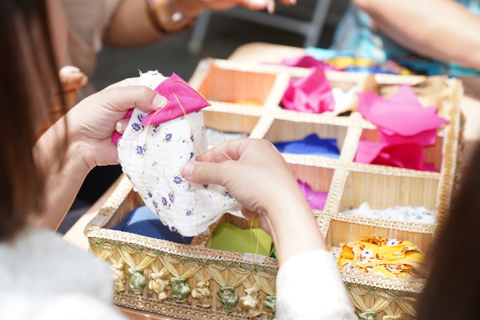 hands sewing cotton fabric scraps workshop
