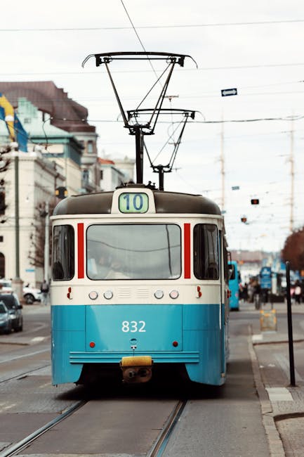 Historic blue tram number 832 riding through Gothenburg, Sweden on a bustling day.