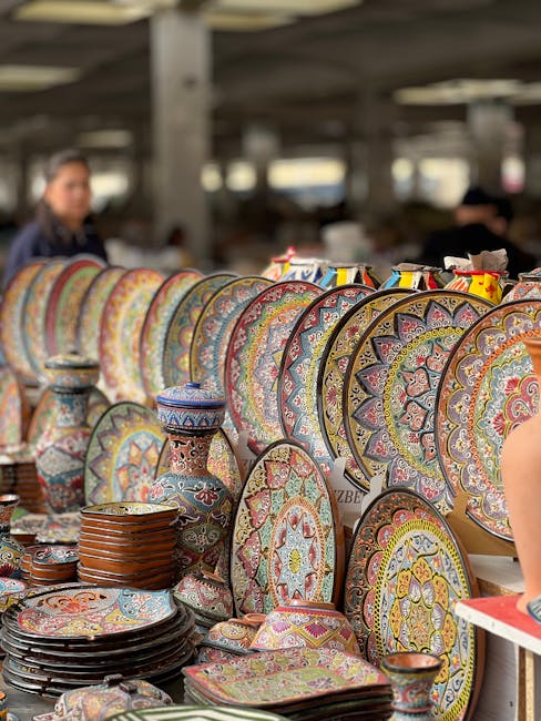 Vibrant display of handcrafted ceramic plates and vases at an outdoor market.