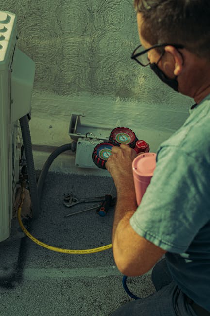 A technician checks and repairs an HVAC system outdoors using tools and gauges.