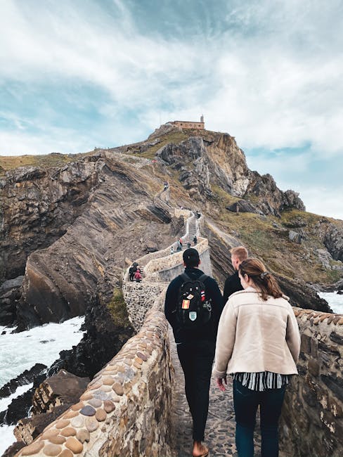 Tourists walking up the scenic stairs of Gaztelugatxe, an iconic island off the coast of Spain.