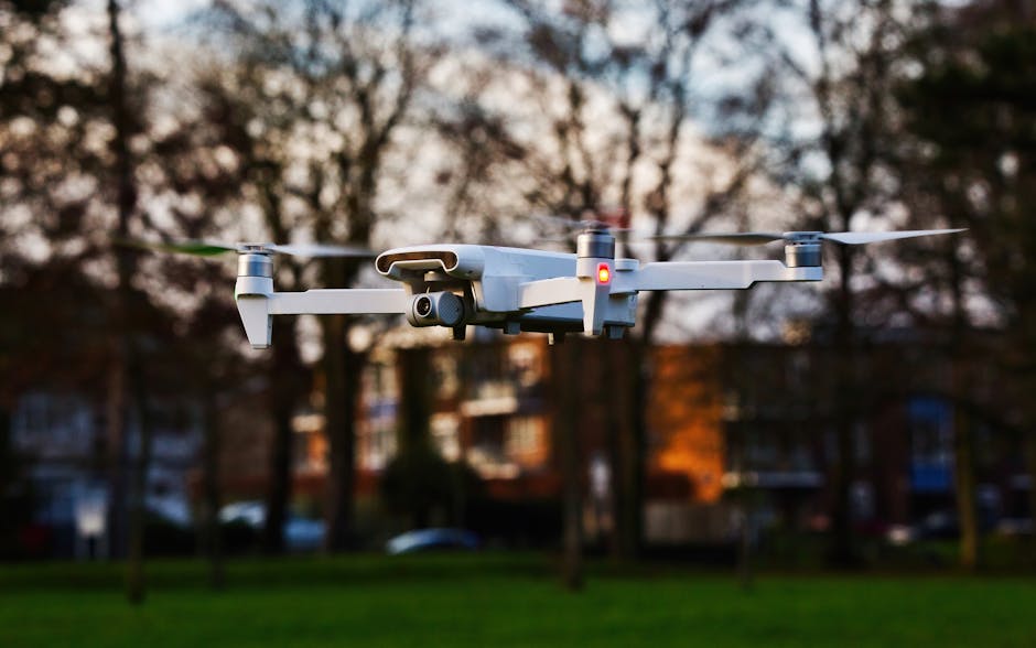 Close-up of a drone flying in a park at sunset. Captures modern technology in outdoor urban setting.