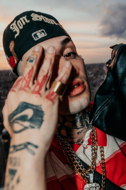 Artistic portrait of a tattooed man with bold jewelry and urban style at sunset in Buenos Aires.