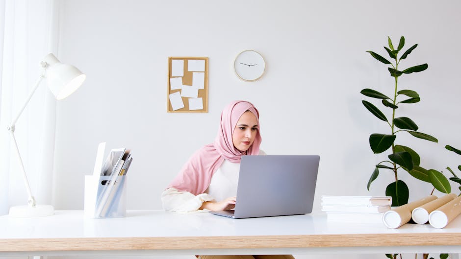 Arab freelancer laptop workspace invoices desk
