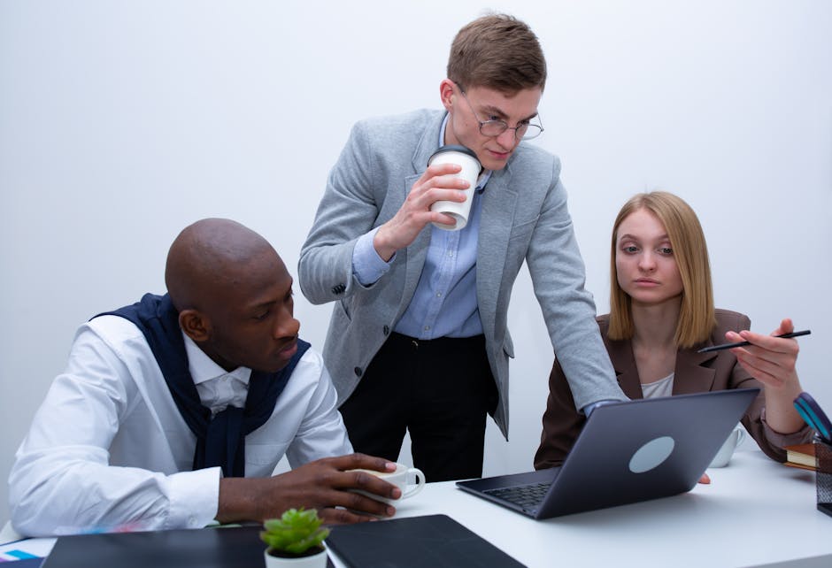 diverse content moderation team meeting laptops online safety