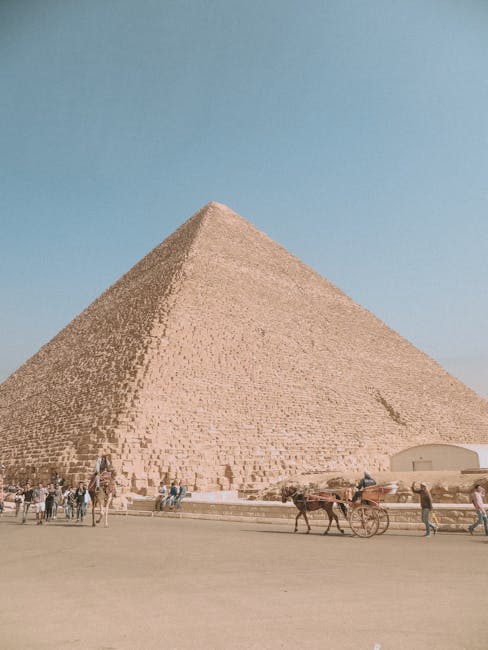 People with horses walking near Pyramid of Cheops largest of Egyptian pyramids monument of architectural art of Ancient Egypt