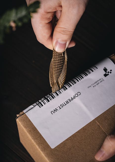 Close-up of a hand opening a package with a wooden tool, ideal for delivery or ecommerce themes.