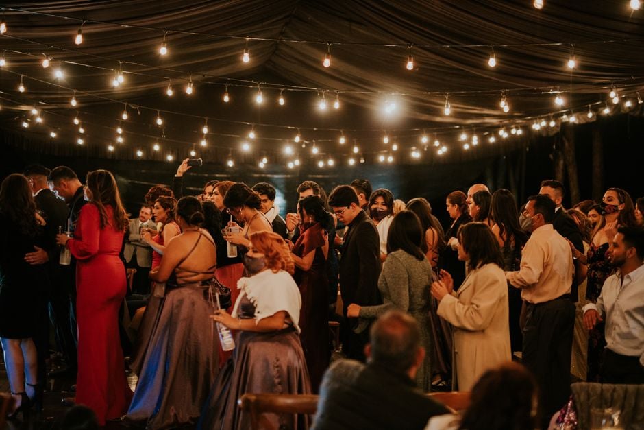 community dance night string lights diverse group indoor outdoor