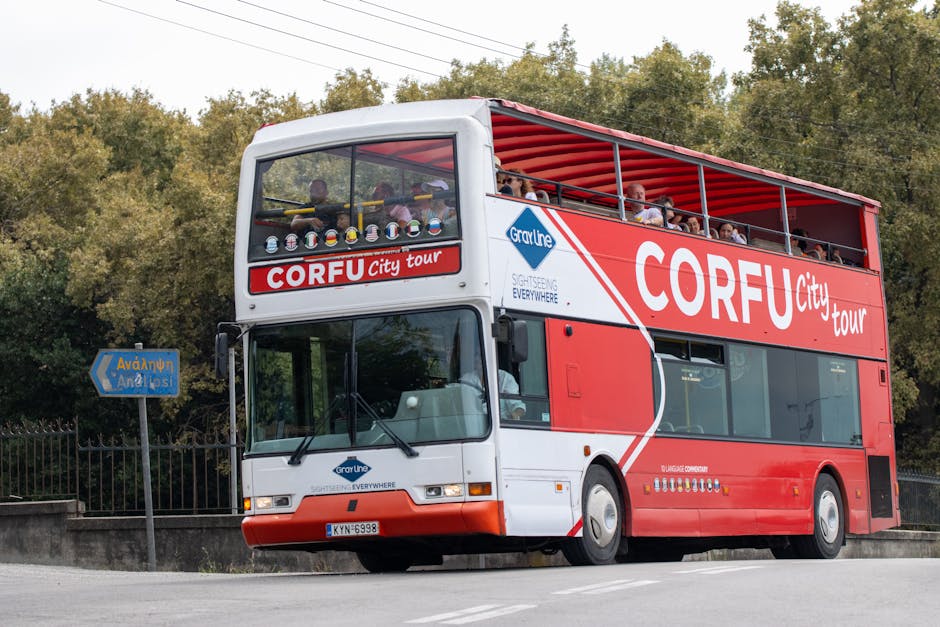 Explore Corfu with this vibrant open-top city tour bus featuring multilingual commentary.