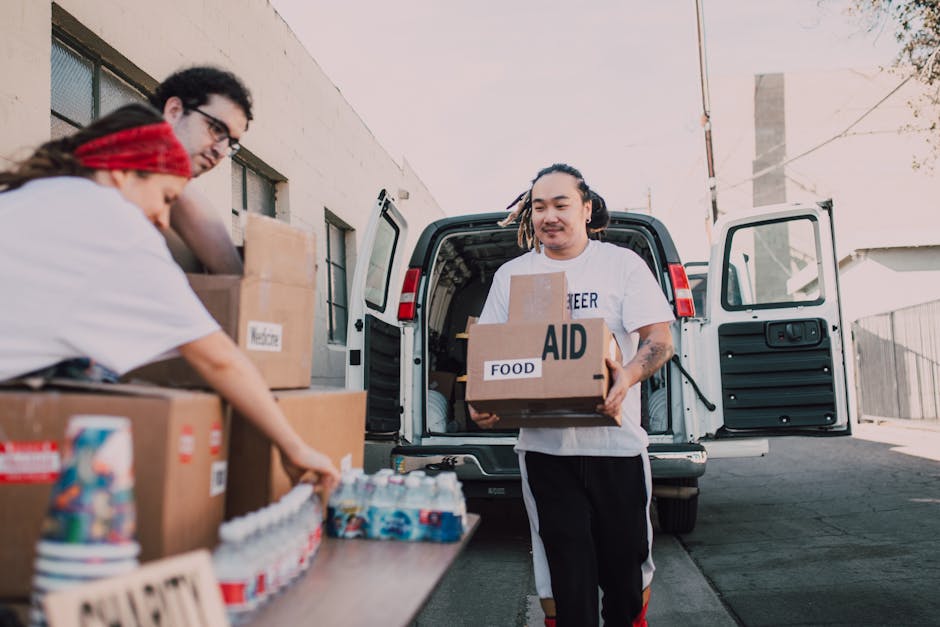 Volunteers organizing and distributing aid from a van, supporting community efforts.