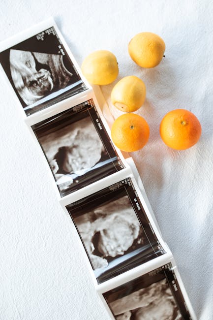 Ultrasound images paired with lemons and oranges on white fabric.