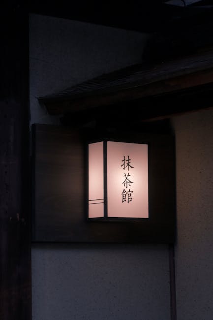 Illuminated lantern with Japanese script in Kyoto's peaceful evening ambiance.