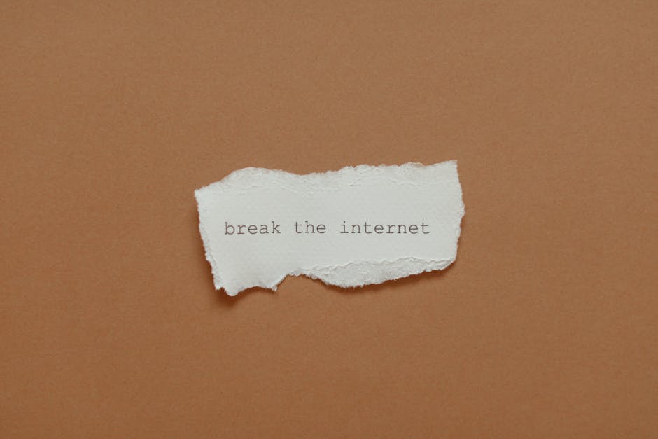 Minimalist torn paper with "break the internet" phrase on brown background.