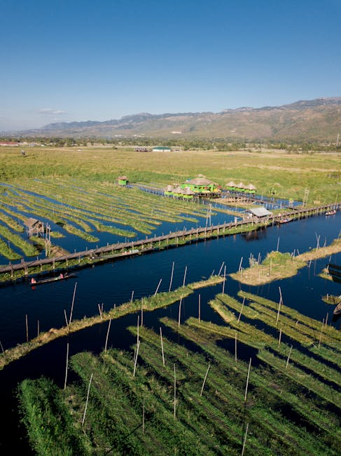 Scenic aerial view of Shan countryside with floating farms and stilt houses in Myanmar.