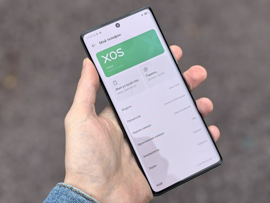 Person holding smartphone showing XOS interface on the screen, captured outdoors.