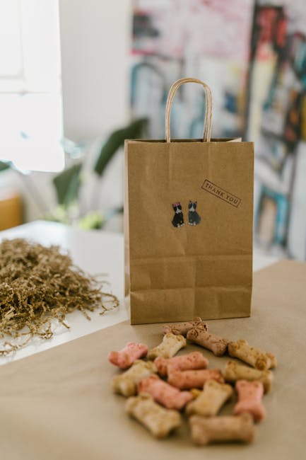 Brown paper bag with dog treats and a 'thank you' sticker, embodying sustainability and small business branding.