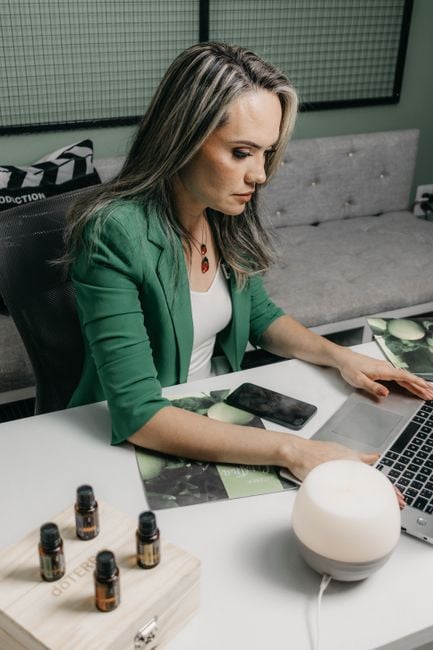 woman using tablet near smart diffuser home office